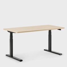 an electric standing desk with a wooden top and black legs, on a white background