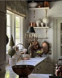 a kitchen filled with lots of pots and pans