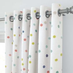 polka dot curtains hanging on the side of a window