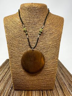 Brown Circle Pendant Necklace Experience the allure of nature and elegance. 🌳 Features:   - Natural Elegance: Flaunt a beautiful and natural wood design. Crafted with meticulous attention to detail, this pendant showcases the warm hues and rich patterns of genuine wood. - Versatility Unlocked: Unisex design makes it perfect for everyone, irrespective of gender. It's a piece that transcends style boundaries. - Optimal Size: Pendant measures a symmetrical 2.25" x 2.25", making it a statement with Adjustable Wood Jewelry Nature-inspired, Adjustable Wood Jewelry In Nature-inspired Style, Adjustable Natural Wood Necklace Nature-inspired, Natural Beaded Nature-inspired Jewelry, Adjustable Artisan Natural Wood Necklace, Adjustable Nature-inspired Wooden Jewelry, Natural Wood Necklaces With Wooden Beads For Gift, Gift Wooden Bead Necklaces In Natural Wood, Round Natural Color Necklace As Gift