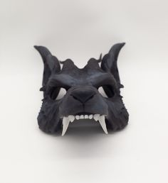 an animal mask with sharp teeth on a white background