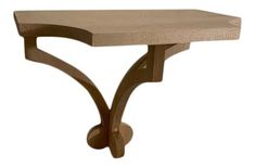 a wooden table with a curved design on it's top and bottom edge, against a white background