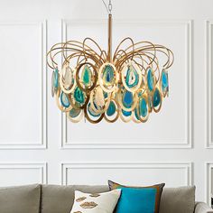 a living room filled with furniture and a chandelier hanging from it's ceiling