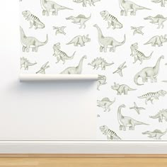 a wall with dinosaurs on it and a roller blind in the corner, next to a wooden floor