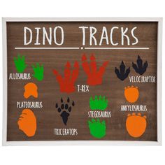 a wooden sign that says dino tracks with different types of animals and their names on it