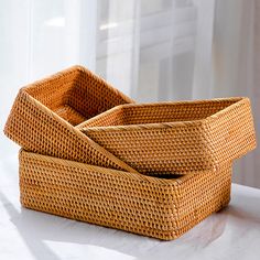 three woven baskets sitting on top of a table