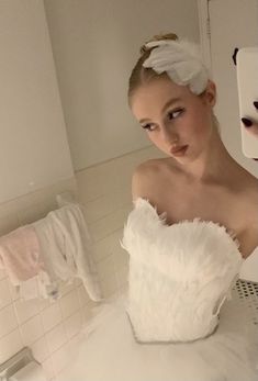 a woman in a white dress is taking a selfie with her dog on the mirror