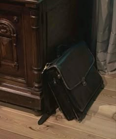 a suitcase sitting on the floor next to a cabinet