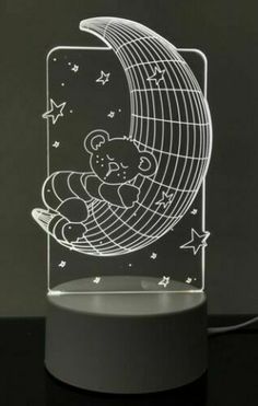 a night light with a teddy bear sleeping on the moon and stars in the sky