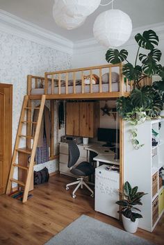 there is a loft bed with a desk underneath it and a ladder to the top