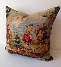 a decorative pillow with an image of two women walking on a bridge and trees in the background