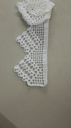 white crocheted doily on top of a table with two pieces of cloth