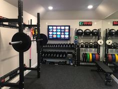 a home gym with weight machines, barbells and other equipment