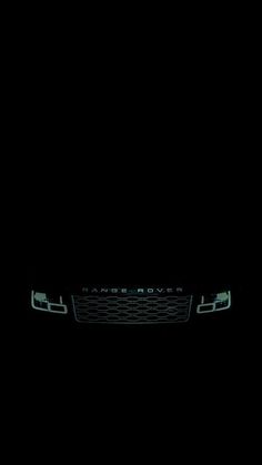 the front grille of a black car in the dark