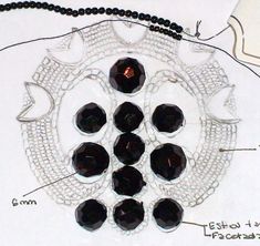 the beads are arranged in a circle on top of a white plate with black beading