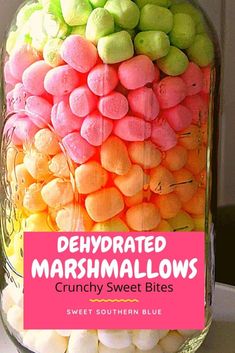 a jar filled with candy marshmallows on top of a white countertop