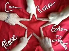 four hands in the shape of a star with names written on them