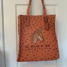 The Unicorn Tote By Coach Mixes Whimsical Style With Classic Designer Polish On This Easygoing Bag That Can Carry It All. Medium Sized Bag; 13"W X 13-1/2"H X 5-1/4"D (Width Is Measured Across The Bottom Of Handbag); 1.10 Lbs. Approx. Weight 9-1/2"L Strap Snap Closure Style No.: 26971 Canvas Coach Unicorn Stars Pink Canvas Tote Purse Bag Rare Coach Unicorn Tote, Coach Zip Top Tote, Python Bags, Leopard Tote, Reversible Tote Bag, Whimsical Style, Coach Tote Bags, Beige Bag, Red Tote