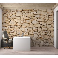 an office with a stone wall in the background and a computer chair next to it