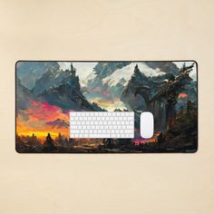 a computer mouse pad with an image of a mountain range in the background and a keyboard on it