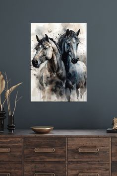 two horses are running together on the wall in this room with grey walls and wooden dressers