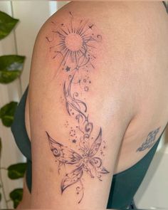 the back of a woman's shoulder with an artistic tattoo design on her arm