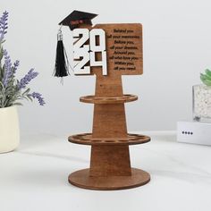 a wooden stand with a graduation cap and tassel on it