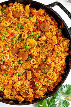 chicken and rice paella in a skillet with the title overlay above it