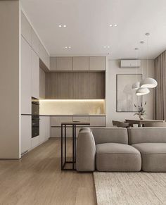 a living room filled with furniture next to a kitchen