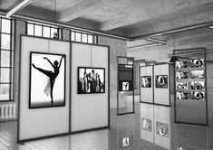 an art gallery with multiple pictures on the wall and in front of them is a woman dancing