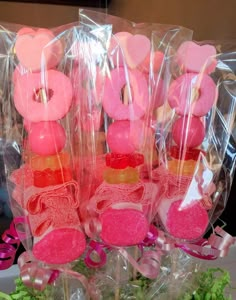 pink donuts wrapped in cellophane and placed on top of each other with ribbons