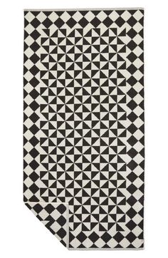 a black and white rug with triangles on it