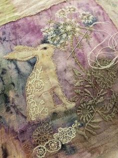 a close up of a piece of cloth with an animal and flowers design on it