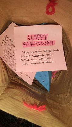 a piece of paper that has been placed on top of a cardboard box with the words happy birthday written on it