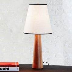 a lamp on a table next to some books