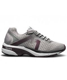 a woman's running shoe in grey and white with purple accents on the sole