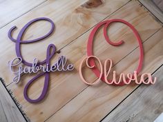 two wooden letters that spell out the word garfelle and livva on a table