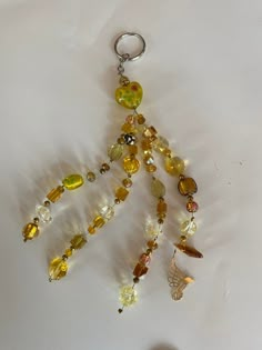 a bunch of different colored beads hanging from a keychain