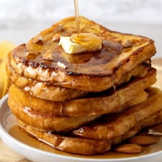 a stack of french toast with butter and syrup