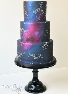 a three tiered cake with stars painted on it