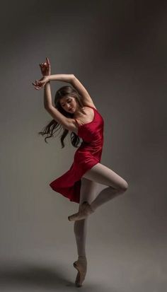 a woman in a red dress is dancing