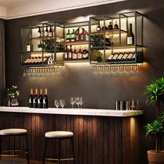 a bar with several bottles and glasses on it, along with two stools in front of the bar