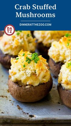 baked crab stuffed mushrooms on a baking sheet with text overlay that reads crab stuffed mushrooms