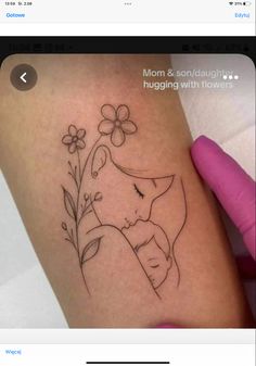 a woman's arm with a tattoo on it and flowers in the corner next to her