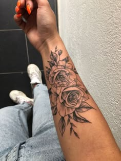 a person with a flower tattoo on their arm