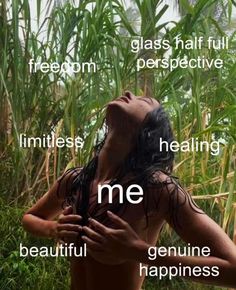 a woman with her eyes closed standing in front of some tall grass and looking up at the sky