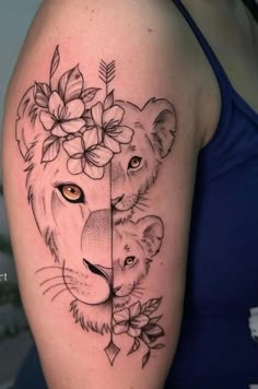 a woman's arm with a lion and flower tattoo on the left side of her body