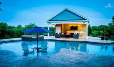 an outdoor living area with a pool and patio furniture, lit up by the evening sun