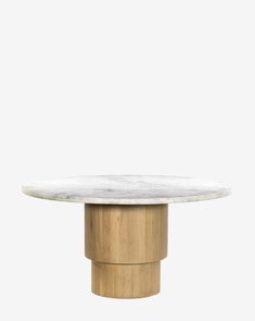 a round marble table with wooden pedestals on the top, against a white background