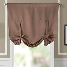 a window with a brown curtain hanging from it's side